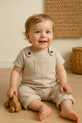 Baby in beige overalls