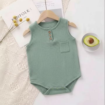 Green baby romper flat lay